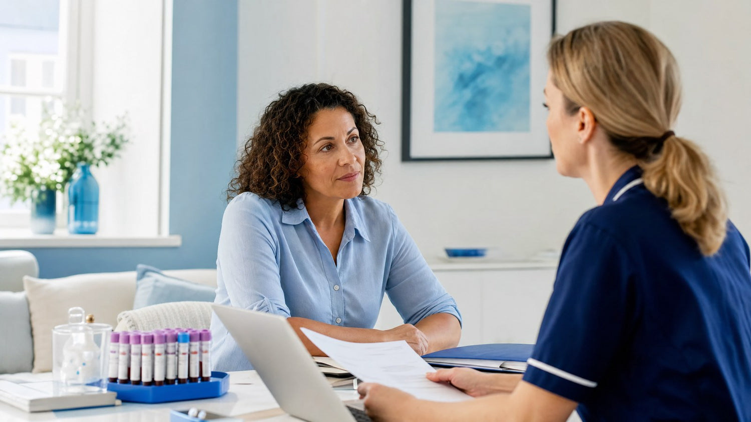 A woman looking thoughtfully at a pregnancy test, contemplating the importance of early detection.
