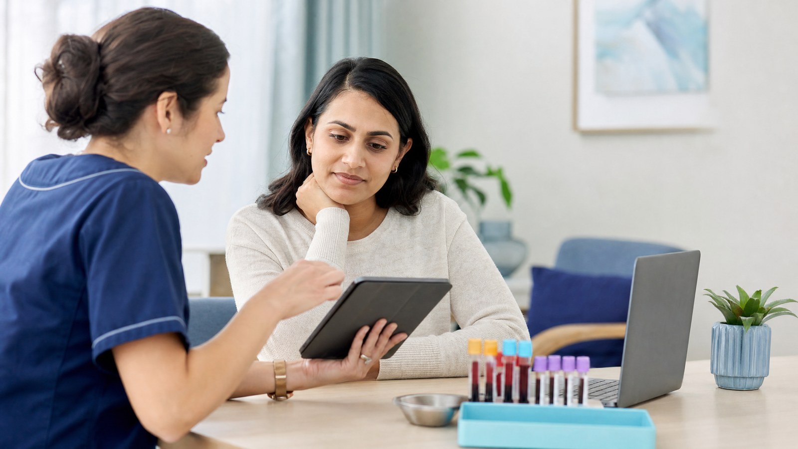 A woman reviewing her Tumour Markers Female Blood Test results with a healthcare professional.
